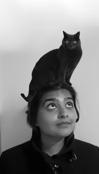 A photoshop of Sameera with her cat on her head